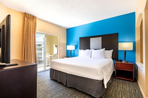 a hotel room with a bed and a tv at Vacation Village at Parkway in Orlando