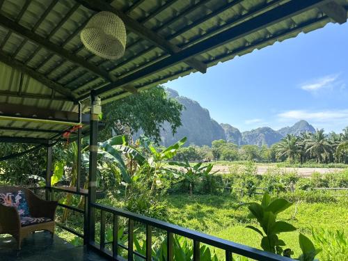 a view from the porch of a house with mountains in the background at Baan Suanthip Homestay - Aoluek Natural Retreat in Ao Luk