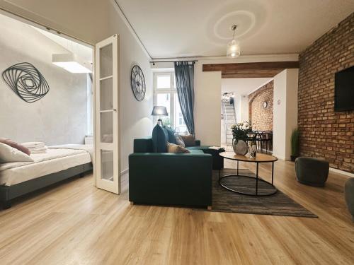 a living room with a couch and a table at Soft Loft Apartamenty in Toruń