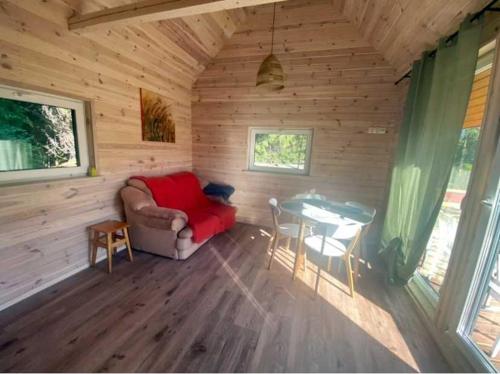 a room with a couch and a table in a cabin at Trzy sosny in Supraśl