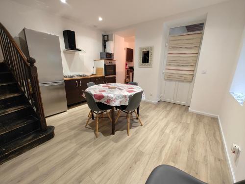 a kitchen and dining room with a table and chairs at Gîte des Pleiades in Villemoirieu
