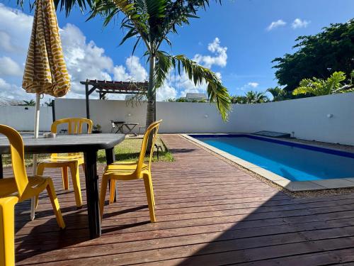 a patio with a table and chairs next to a swimming pool at Sunny Side Up - Private 3BR villa with pool in Grand Baie