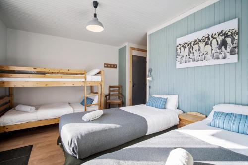 a bedroom with two beds and a bunk bed at CHALET AUBERGE - Les Mélèzes in Tignes