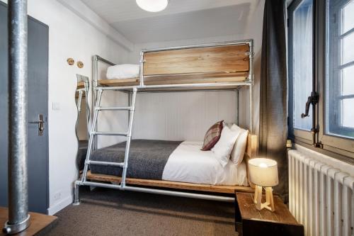 a bedroom with a bunk bed with a ladder at CHALET AUBERGE - Les Mélèzes in Tignes