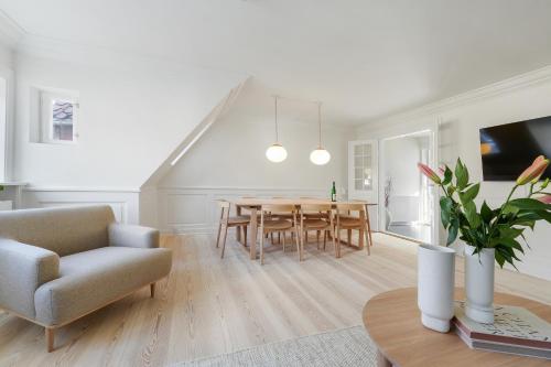 a living room with a dining room table and a couch at Luxury Apartment GBT5 in Copenhagen