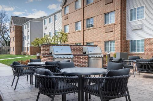 a patio with tables and chairs in front of a building at TownePlace Suites by Marriott Annapolis in Annapolis