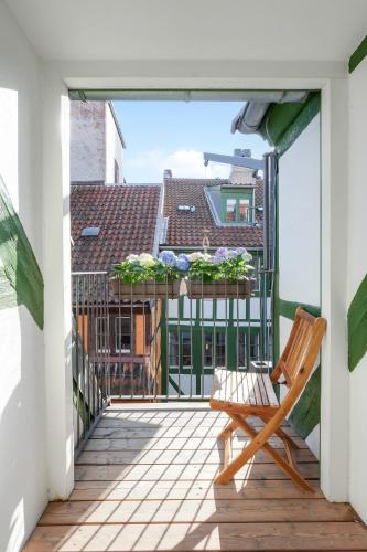 a wooden chair on a balcony with a view at Luxury Apartment GBT5 in Copenhagen