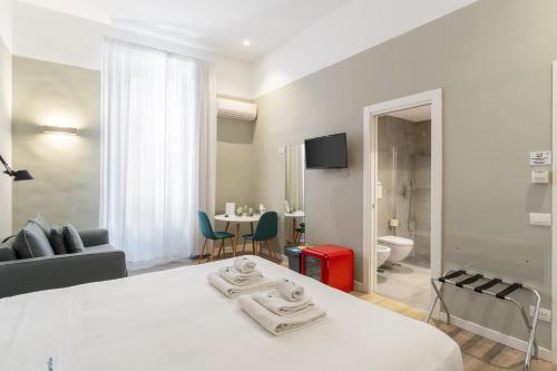 a bedroom with a bed and a living room at Napoli Visit Home in Naples
