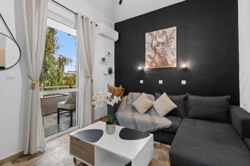 a living room with a couch and a table at Andy’s apartments in Georgioupolis