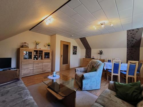 a living room with a couch and a table at Lorenz große FeWo mit sonnigem Balkon in ruhiger Lage in Silberstedt