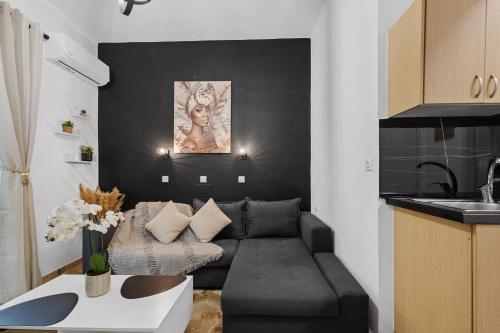 a living room with a couch and a table at Andy’s apartments in Georgioupolis