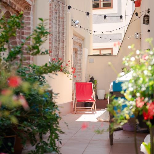 a red chair sitting in the middle of a courtyard at Women's Only Hostel - Female Only in Prague