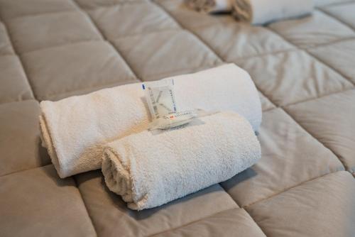 a towel on a bed with a scale on it at Rapallo Center Sea Just Steps Away - Aria Condizionata - WiFi in Rapallo