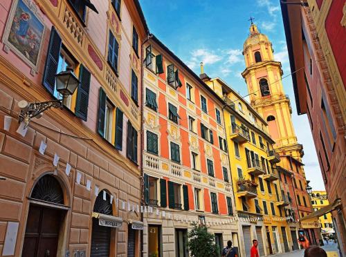 a building with a clock tower on a street at Rapallo Center Sea Just Steps Away - Aria Condizionata - WiFi in Rapallo