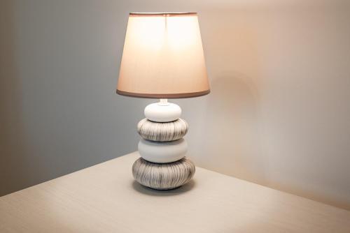 a white lamp sitting on top of a table at Rapallo Center Sea Just Steps Away - Aria Condizionata - WiFi in Rapallo