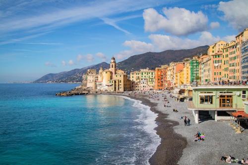 a view of a beach with buildings and the ocean at Rapallo Center Sea Just Steps Away - Aria Condizionata - WiFi in Rapallo