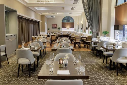a dining room filled with tables and chairs at Hilton York in York
