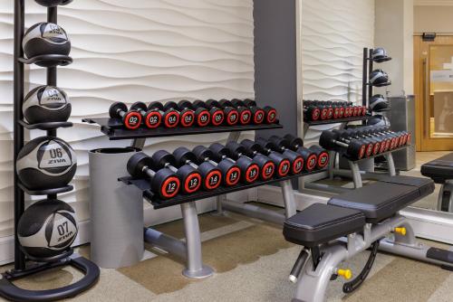 a gym with a row of dumbbells and weights at Hilton York in York