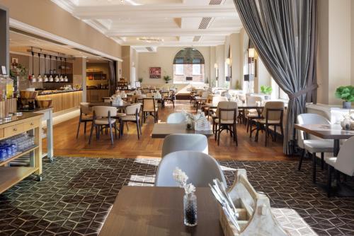 a restaurant with tables and chairs and a bar at Hilton York in York