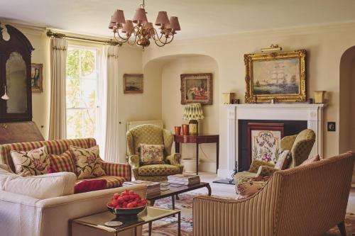 a living room filled with furniture and a fireplace at Hockham Grange in Hockham
