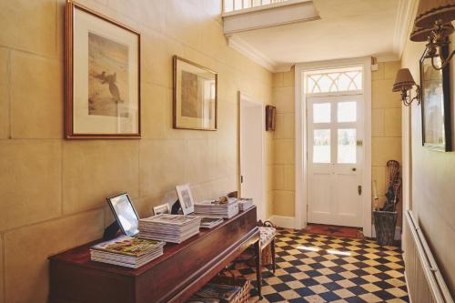 a room with a table with books on it at Hockham Grange in Hockham