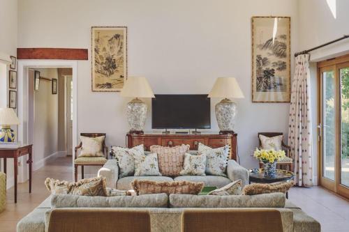 a living room with a couch and a tv at Hockham Grange in Hockham