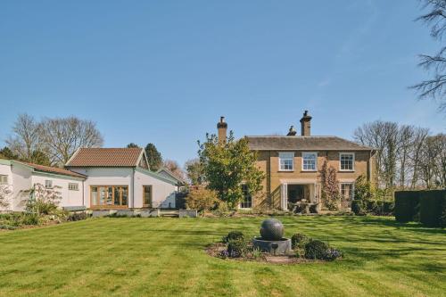 a large house with a large yard with a house at Hockham Grange in Hockham