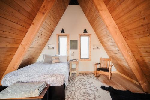 a bedroom with a bed in a attic at River End A-Frame in Emily