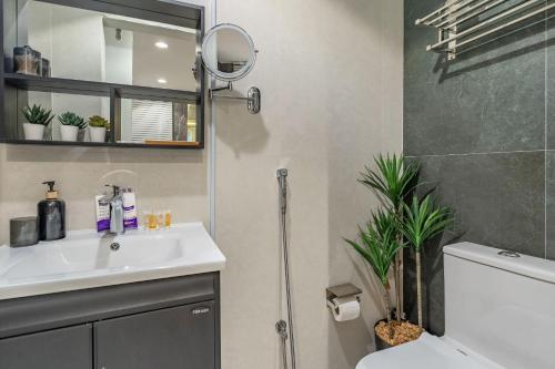 a bathroom with a sink and a toilet and a mirror at استديو فاخر سرير كينج ومطبخ Luxury Studio King Bed in Riyadh