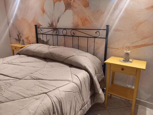 a bedroom with a bed and a table with a lamp at La Collina in Sacrofano