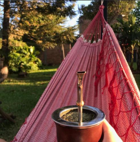 a person holding a pot with a plant in a hammock at Cabañas Doralia in Oberá