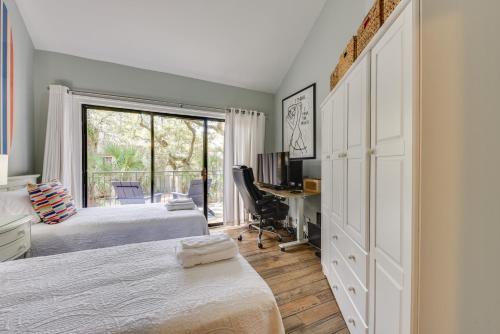a bedroom with two beds and a desk and a window at Tennis, Golf and More Seabrook Island Getaway! in Seabrook Island