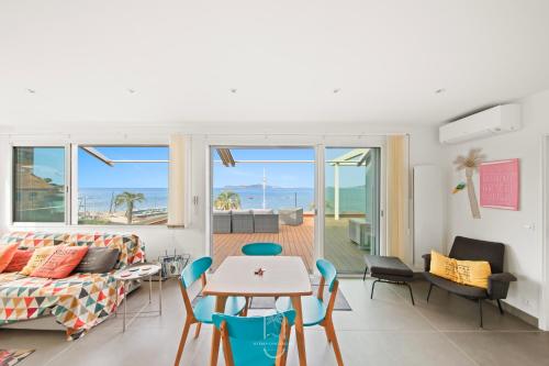 un salon avec un canapé, une table et des chaises dans l'établissement Villa Antoine 1er étage Vue Mer La Garonne WiFi PK By HC, au Pradet