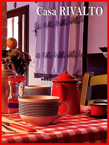 a table with plates and cups and a tea pot at Casa RIVALTO - Antiche Dimore Pisane in Rivalto