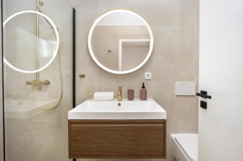 a bathroom with a sink and a mirror at Olea Delux Rooms in Zadar