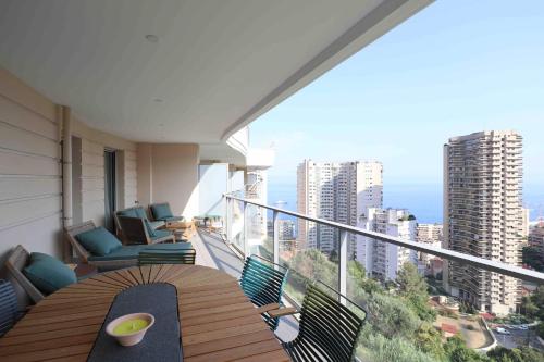 a balcony with a table and chairs on a building at Sun Paradise SeaView&Terrace Parking&Pool in Beausoleil