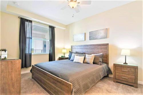 a bedroom with a large bed and a window at Beautiful Condo Only 6 Minutes From Disney World in Kissimmee