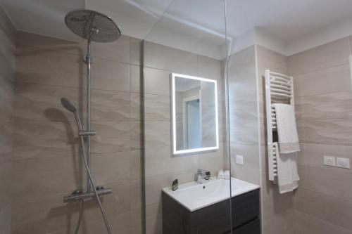 a bathroom with a shower and a sink and a mirror at Sun Paradise SeaView&Terrace Parking&Pool in Beausoleil