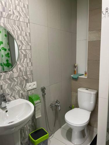 a bathroom with a white toilet and a sink at Готель GUEST HOUSE Сауна in Radekhov