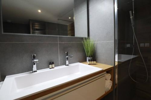 a bathroom with a white sink and a mirror at Sun Paradise SeaView&Terrace Parking&Pool in Beausoleil