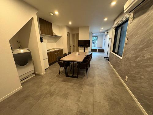 a kitchen and dining room with a table and chairs at COTO Shibuya Premium Garden in Tokyo