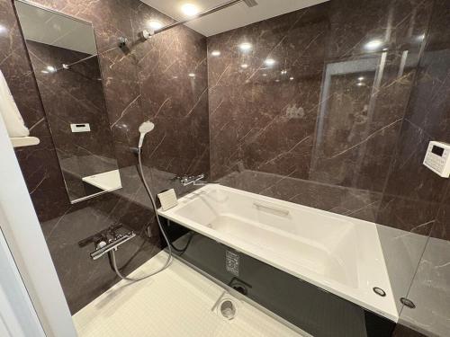 a bathroom with a sink and a shower at COTO Shibuya Premium Garden in Tokyo