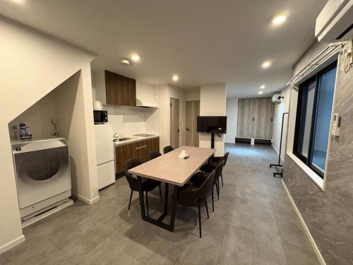 a kitchen and dining room with a table and chairs at COTO Shibuya Premium Garden in Tokyo