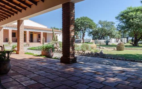 a patio with a brick pillar in a yard at La Vaca Tranquila in San Carlos
