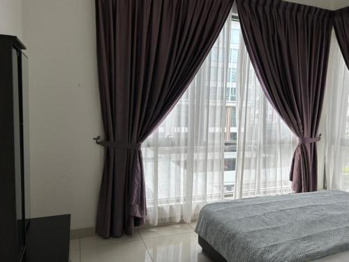 a bedroom with a bed and a large window at BS Homestay2 - 1 Bedroom Apartment in Miri Times Square in Miri