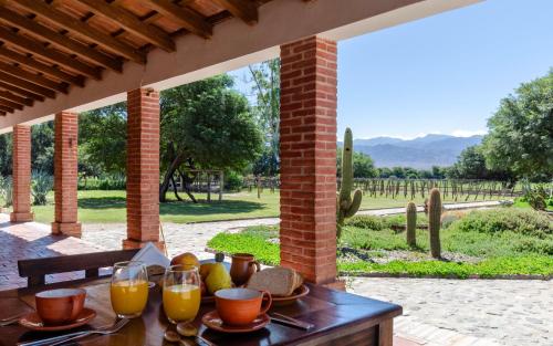 a wooden table with glasses of orange juice on it at La Vaca Tranquila in San Carlos