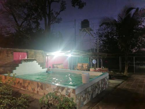 a person in a swimming pool at night at Casa pura vida Rivas in Rivas