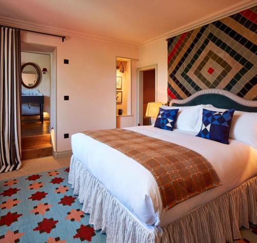 a bedroom with a large bed in a room at Penmaenuchaf Hotel in Dolgellau