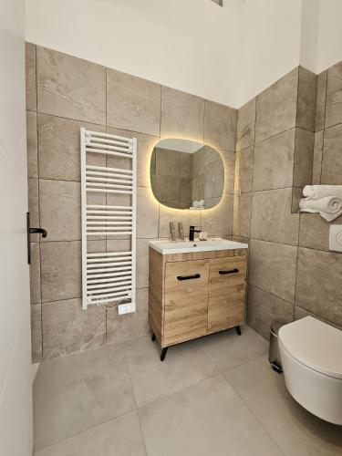 a bathroom with a sink and a mirror and a toilet at Villa Berlioz in Nice