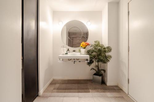 a bathroom with a sink and a mirror at Majestic Villa in Downtown Griffintown in Montréal